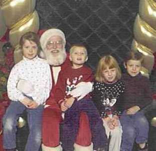 On Santa's lap, Julia Isom, Anthony and Brianna de Gaston, Gregory Isom, December 2001